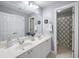 This bathroom features a double vanity, a large mirror, and shower with neutral-patterned curtain at 4350 Oakdale Vinings Se Cir, Smyrna, GA 30080