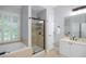 Stylish bathroom featuring a soaking tub, a glass-enclosed shower, and neutral-toned tiled floors at 4350 Oakdale Vinings Se Cir, Smyrna, GA 30080