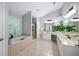 Bright bathroom featuring double vanities, a soaking tub, a glass-enclosed shower, and tiled floors at 4350 Oakdale Vinings Se Cir, Smyrna, GA 30080