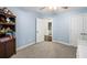 Bright bedroom features blue walls, carpet floors, ceiling fan, and a dark bookcase filled with toys at 4350 Oakdale Vinings Se Cir, Smyrna, GA 30080