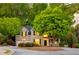 Charming brick home with lush landscaping, mature trees, and a cozy front porch at 4350 Oakdale Vinings Se Cir, Smyrna, GA 30080