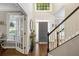 Inviting foyer with hardwood floors, staircase, and entry to bright and airy living spaces at 4350 Oakdale Vinings Se Cir, Smyrna, GA 30080