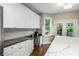 Well-lit kitchen with island seating, stainless appliances, and easy access to outdoor deck at 4350 Oakdale Vinings Se Cir, Smyrna, GA 30080