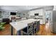 Open kitchen with island seating, stainless appliances, and seamlessly connects to the living area at 4350 Oakdale Vinings Se Cir, Smyrna, GA 30080