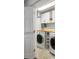 Bright laundry room features lots of shelving, a butcher block counter and front loading washer and dryer at 4350 Oakdale Vinings Se Cir, Smyrna, GA 30080
