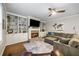 Open-concept living room with a fireplace, built-in shelves, and hardwood floors at 4350 Oakdale Vinings Se Cir, Smyrna, GA 30080