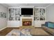 Inviting living room featuring a brick fireplace, built-in shelving, and hardwood floors at 4350 Oakdale Vinings Se Cir, Smyrna, GA 30080