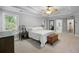 Spacious main bedroom features tray ceilings, carpeted floors, a wooden chest, and abundant natural light at 4350 Oakdale Vinings Se Cir, Smyrna, GA 30080