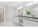 Luxurious bathroom featuring double sinks, quartz countertops, and large mirrors at 4775 Columbia St, Cumming, GA 30040