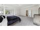 Spacious primary bedroom featuring neutral colors and a large window with a wooded view at 4775 Columbia St, Cumming, GA 30040