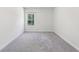 Neutral bedroom with light gray carpet, white walls and window bringing in light at 4775 Columbia St, Cumming, GA 30040