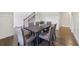 Open dining area boasting gorgeous hardwood floors and modern wainscoting detail at 4775 Columbia St, Cumming, GA 30040