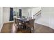 Dining room showcasing hardwood floors, staircase with black iron spindles, and lovely natural light at 4775 Columbia St, Cumming, GA 30040