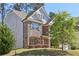 Well-maintained two-story house with a blend of stone and brick accents, surrounded by lush greenery and a neatly kept lawn at 4775 Columbia St, Cumming, GA 30040
