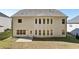 Rear exterior view of this two-story home highlighting the light siding and multiple windows at 4775 Columbia St, Cumming, GA 30040