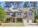 Charming two-story home featuring a stone and brick facade, complemented by a well-manicured lawn and a two-car garage at 4775 Columbia St, Cumming, GA 30040