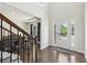 Inviting foyer with hardwood floors, a staircase with iron spindles, and a view into the dining area at 4775 Columbia St, Cumming, GA 30040