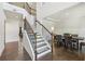 Spacious foyer features hardwood floors, a staircase with dark wood railings, and an elegant dining area at 4775 Columbia St, Cumming, GA 30040