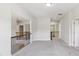 Hallway features neutral walls and soft carpet flooring with wrought iron railing at 4775 Columbia St, Cumming, GA 30040