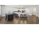 Open kitchen featuring a large island, stainless appliances, white cabinets, and a casual dining area at 4775 Columbia St, Cumming, GA 30040