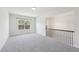 Inviting living space filled with natural light and featuring neutral walls and soft carpet flooring at 4775 Columbia St, Cumming, GA 30040