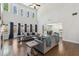 Open-concept living room featuring high ceilings, hardwood floors, a fireplace, and views of the backyard at 4775 Columbia St, Cumming, GA 30040