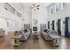 Large living room with hardwood floors, a fireplace, and tall windows offering a bright and airy atmosphere at 4775 Columbia St, Cumming, GA 30040