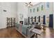 Bright living room with soaring ceilings, a fireplace, hardwood floors, and large windows with backyard views at 4775 Columbia St, Cumming, GA 30040
