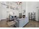 Spacious living room with hardwood floors, a cozy fireplace, and large windows providing ample natural light at 4775 Columbia St, Cumming, GA 30040