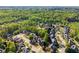 An aerial view of a quiet residential neighborhood surrounded by lush greenery and mature trees at 975 Garden Crossing Ln, Cumming, GA 30040