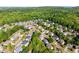 An aerial view of a neighborhood with tree-lined streets and well-maintained homes at 975 Garden Crossing Ln, Cumming, GA 30040