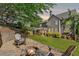 Spacious backyard with a fire pit, Adirondack chairs, and a covered patio for outdoor entertaining at 975 Garden Crossing Ln, Cumming, GA 30040