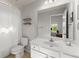 Bright bathroom featuring a white toilet, vanity, and shower with curtain at 975 Garden Crossing Ln, Cumming, GA 30040