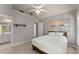 Bright bedroom with vaulted ceiling, white linen bedding, and ensuite bathroom at 975 Garden Crossing Ln, Cumming, GA 30040