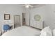 Bright bedroom with white furniture, desk, and ceiling fan at 975 Garden Crossing Ln, Cumming, GA 30040