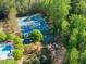 Aerial view of community amenities including a tennis court, basketball court, playground, pool and clubhouse at 975 Garden Crossing Ln, Cumming, GA 30040