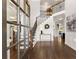 Bright and airy foyer with hardwood floors, a staircase with iron railings, and elegant decor at 975 Garden Crossing Ln, Cumming, GA 30040