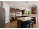 Modern kitchen with a center island, granite countertops, and stainless steel appliances at 975 Garden Crossing Ln, Cumming, GA 30040