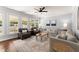 Spacious living room featuring hardwood floors, neutral walls, ample seating, and large windows with natural light at 975 Garden Crossing Ln, Cumming, GA 30040