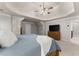 Large main bedroom with tray ceilings, walk-in closets, and an attached bathroom at 975 Garden Crossing Ln, Cumming, GA 30040
