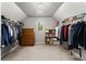 Spacious walk-in closet with clothing racks and storage shelving at 975 Garden Crossing Ln, Cumming, GA 30040
