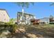Expansive backyard view with a two-story home, wooden deck, and lush landscaping at 1517 Granby Ln, Locust Grove, GA 30248