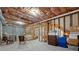 Partially finished basement area with exposed ceiling, furniture, and concrete floor at 1517 Granby Ln, Locust Grove, GA 30248
