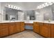 The bathroom features a double vanity, a corner makeup table, and two large mirrors at 1517 Granby Ln, Locust Grove, GA 30248