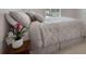 Bedroom featuring a plush bed with elegant patterned bedding and a wooden side table at 1517 Granby Ln, Locust Grove, GA 30248