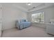 Well-lit bedroom showcasing a cozy daybed, bright window, and a wicker desk at 1517 Granby Ln, Locust Grove, GA 30248