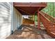 Exterior view under wooden deck, showing access door and backyard landscape at 1517 Granby Ln, Locust Grove, GA 30248