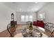 Bright dining room with glass table, seating, and ample natural light at 1517 Granby Ln, Locust Grove, GA 30248