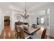 Elegant dining room with a chandelier, wooden table, and classic decor at 1517 Granby Ln, Locust Grove, GA 30248