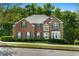 Traditional red brick home with green shutters and meticulously maintained landscaping at 1517 Granby Ln, Locust Grove, GA 30248
